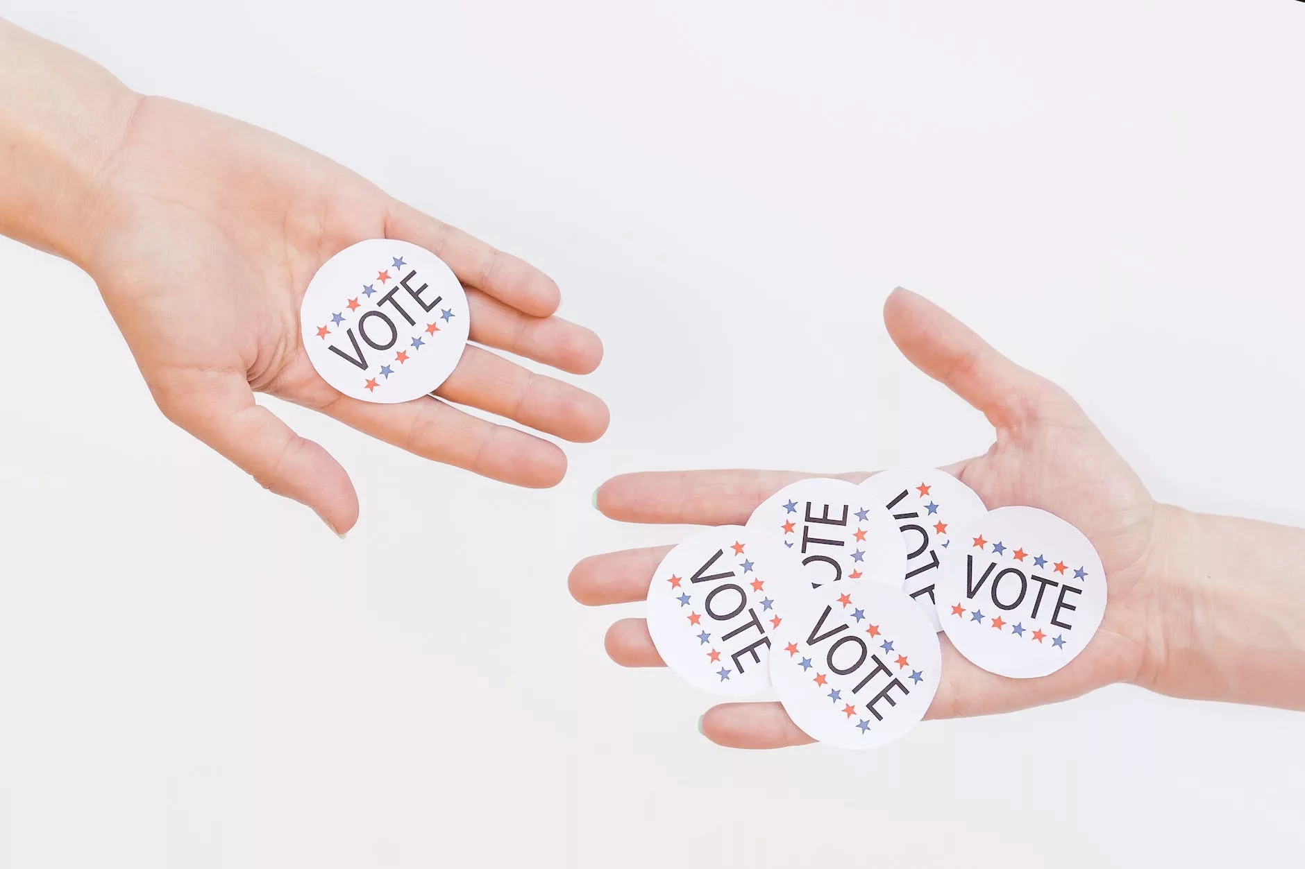 vote badges on person s hand